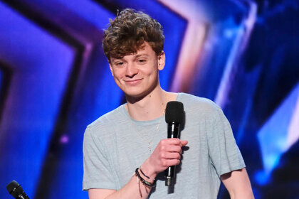 Performer Kieran Rhodes standing on stage