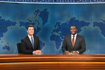 Colin Jost and Michael Che sitting at the Weekend Update desk