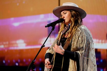 Dani Kerr playing guitar and singing on America's Got Talent.