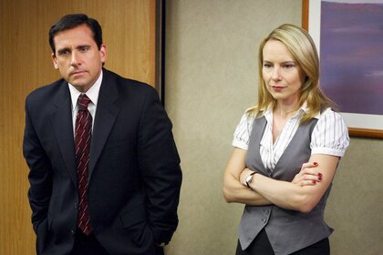 Michael and Holly standing side by side during a scene in The Office.