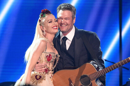 Gwen Stefani and Blake Shelton pose onstage at the GRAMMY Awards