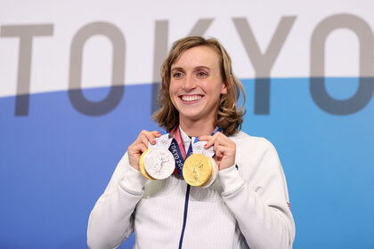 Katie Ledecky holds up her two Gold and two Silver medals