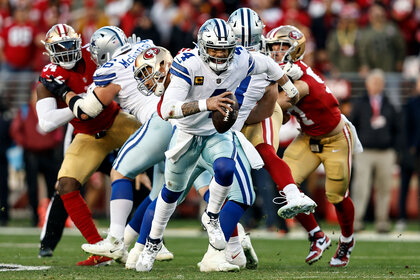 Dak Prescott #4 of the Dallas Cowboys scrambles and runs with the ball during an NFL divisional round playoff football gam