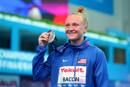 Sarah Bacon holds up her medal during the 2019 FINA World Championships