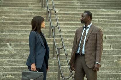 Zee (Nathalie Emmanuel) and Sey (Omar Sy) wear suits in The Killer (2024).