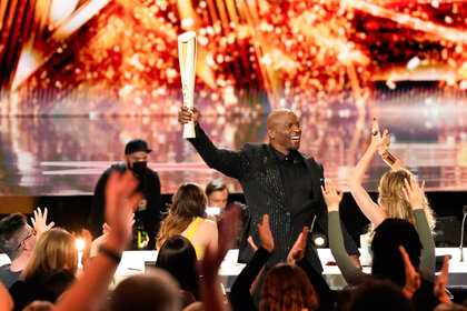 Terry Crews carries the Olympic Torch during America's Got Talent Season 19 Episode 8.