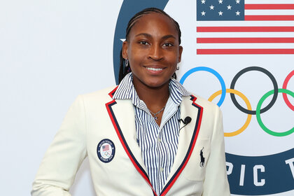 Coco Gauff smiles wearing the us olympics blazer