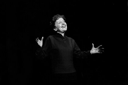 Edith Piaf performing on stage.