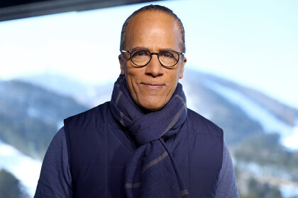 Nightly News anchor Lester Holt in front of a mountain wearing a scarf