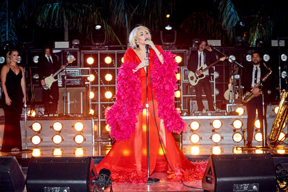 Miley Cyrus wears a pink caftan during a performance on New Years Eve 2021