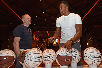 USA Team Assistant, Ellis Dawson talks to Dwight Howard of the USA National Team while he signs jerseys and basketballs