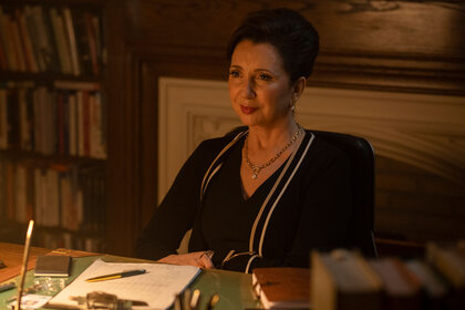 Muriel Lnadon sits at her desk