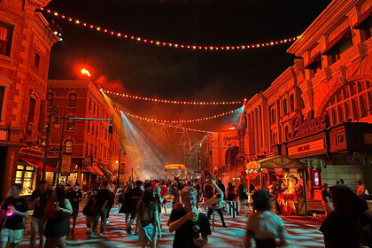 Guests walking around Halloween Horror Nights outdoors.