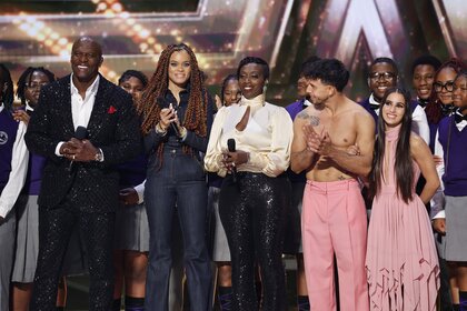 Terry Crews and performers stand onstage on America's Got Talent Episode 1920.