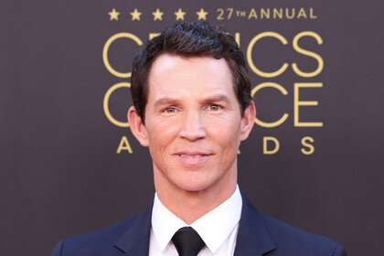 Shawn Hatosy smiling in front of a step and repeat.