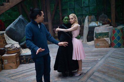 Jon M. Chu directs Elphaba (Cynthia Erivo) and Glinda (Ariana Grande) on the set of Wicked (2024).