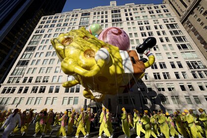 Spongebob Squarepants & Gary balloons float in NYC.