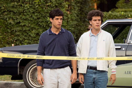 Lyle Menendez and Eric Menendez stand in front of a crime scene on Law And Order True Crime The Menendez Murders