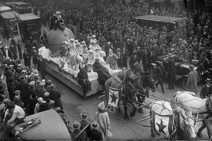 Santa Claus rides a parade float pulled by a team of horses down Broadway Street during the annual Macy's Thanksgiving Day Parade in New York City, 1925.