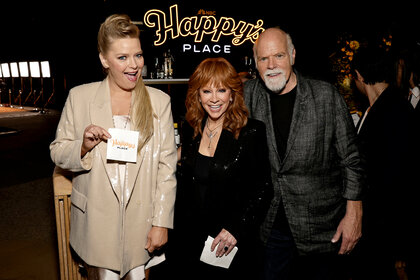 Melissa Peterman Reba Mcentire and Rex Linn smile and pose together at an even for Happy's Place