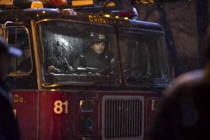 Joe Cruz (Joe Minoso) sits in a fire truck on Chicago Fire Episode 117.