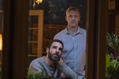 Dr. Oliver Wolf (Zachary Quinto) and Dr. Josh Nicols (Teddy Sears) peer out a window in Brilliant Minds Episode 107.