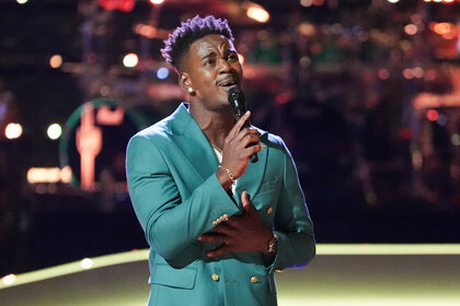 Austyns Stancil sings on stage during The Voice Season 26 Episode 12.