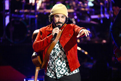 Adam Bohanan sings on stage on The Voice Season 26 Episode 16