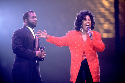 Bebe and Cece Winans perform together on stage