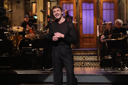 Paul Mescal stands on stage and laughs during the monologue on Saturday Night Live Season 50 Episode 8