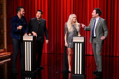 Luke Bryan, Lionel Richie, Carrie Underwood, and Jimmy Fallon on stage talking during the Name That Song Challenge on The Tonight Show Starring Jimmy Fallon Season 12, Episode 79.