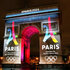 The Paris Olympics 2024 logos are projected onto the Arc de Triomphe.