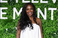 Marlyne Barrett smiles in a white dress.