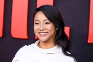 Stephanie Hsu smiles in a white dress.