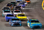 A bunch of cars driving during the NASCAR Cup Series