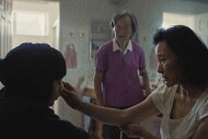 Nai Nai (Chang Li Hua) watches Chungsing Wang (Joan Chen) tend to Chris Wang (Izaac Wang) in Didi (2024).