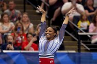 Simone Biles raises her arms at the 2024 U.S. Olympic Gymnastics Trials.