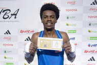 Roscoe Hill holds up a ticket to the Paris Olympics 2024 after a match