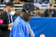 Flavor Flav smiles at a football game between the Detroit Lions and the Tampa Bay Buccaneers