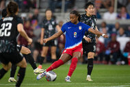 Jaedyn Shaw steals the ball during a soccer match