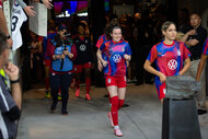 Rose Lavelle runs and enters the field for a soccer match