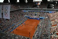 The crowd watches tennis at Roland-Garros at the 2024 Olympics