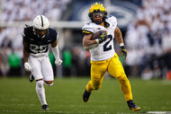 Blake Corum of the Michigan Wolverines runs for a touchdown