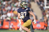 Notre Dame Fighting Irish tight end Cooper Flanagan runs on the field during a football game