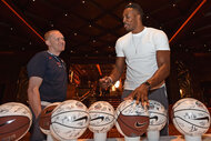 USA Team Assistant, Ellis Dawson talks to Dwight Howard of the USA National Team while he signs jerseys and basketballs