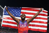 Noah Lyles celebrates winning the gold medal in the Men's 100m Final at the Paris 2024 Olympics