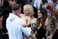 Adam Peaty celebrates with his child and partner Holly Ramsay, following the Swimming medal ceremony after the Men’s 100m Breaststroke Final