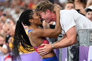 Tara Davis-Woodhall of Team United States celebrates with her husband Hunter Woodhall after winning the gold medal in the Women's Long Jump Finalat the Paris 2024 Olympics