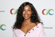 Toya Turner smiles in a light pink sweater at ClexaCon