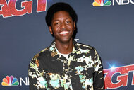 Joseph Allen smiles on the red carpet for Americas Got Talent